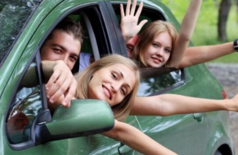 a family enjoying a road trip while looking out a car's window