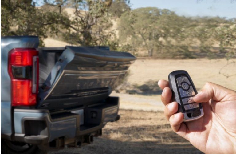 image of a hand opening the rear of a diesel pickup truck