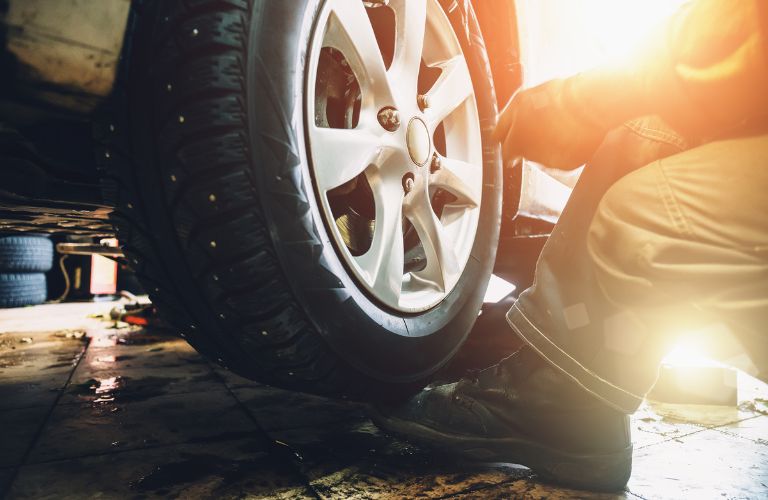 close up of a technician working on a tire