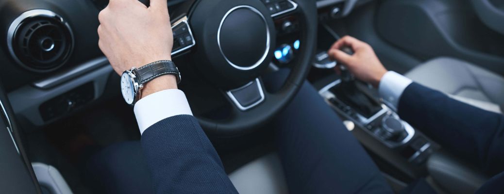 close up of a driver's hands on the steering wheel of a car