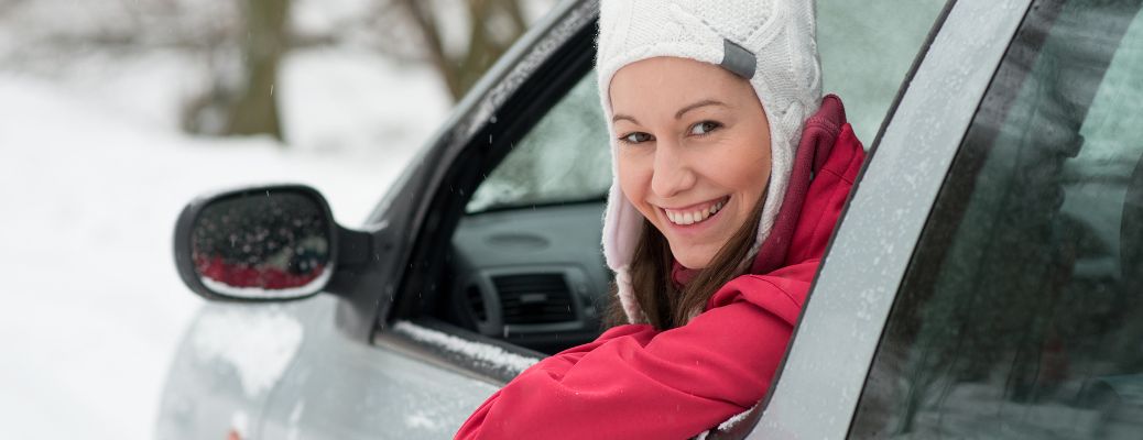 a woman smiling in driving seat