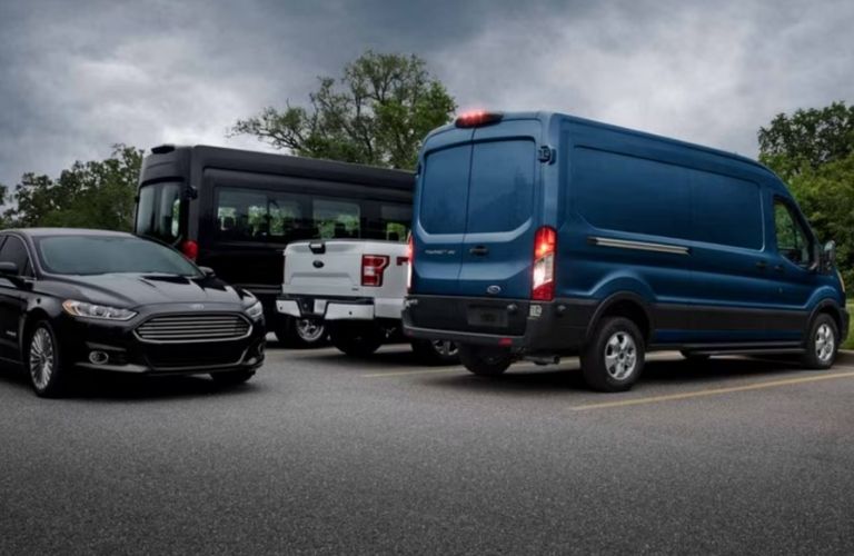 rear view of a Ford backing out with a car blocking it