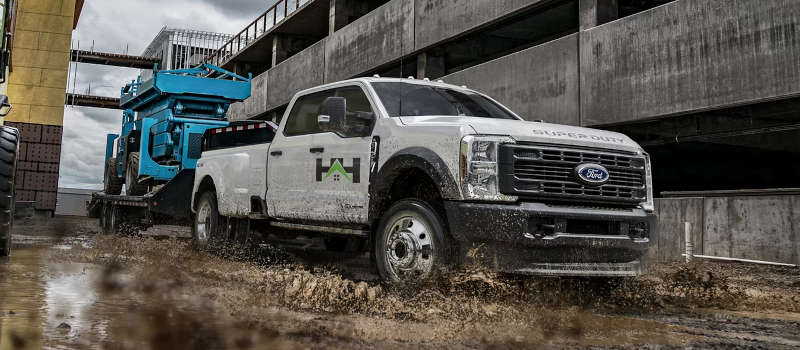 The Ford F-250 towing a heavy piece of equipment.
