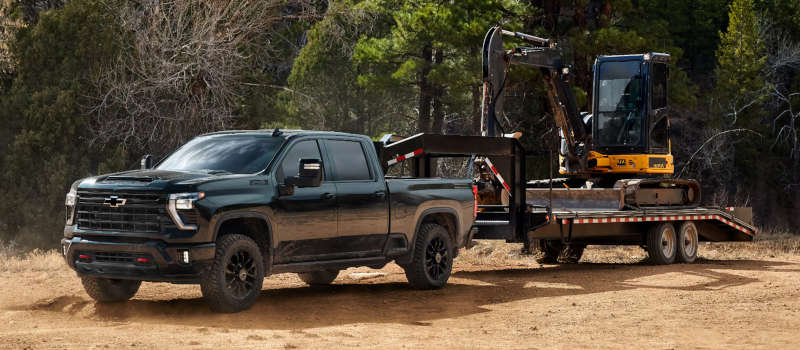 The Chevy Silverado 2500 towing a tractor.