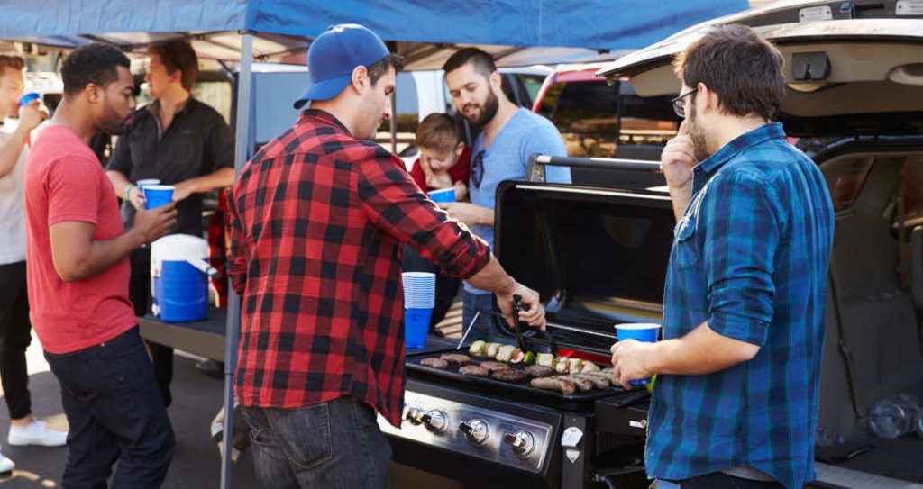 People enjoying a tailgate party using some of the best tailgating accessories of 2026