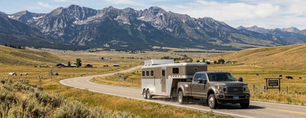 A large diesel pickup truck towing a horse trailer in Montana