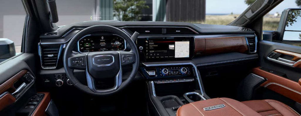 The cockpit of a GMC diesel pickup truck in the Denali trim level.