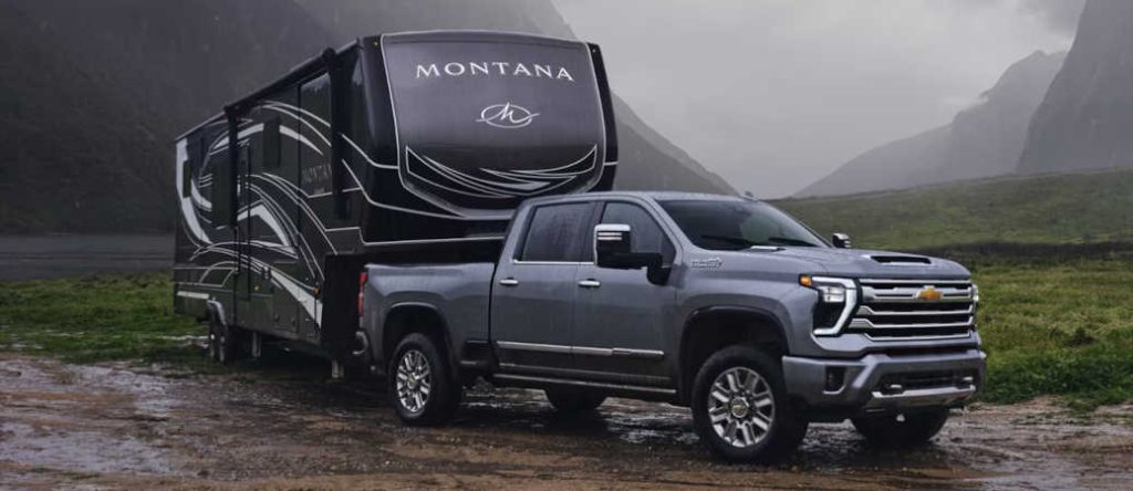 A Chevy Silverado HD with a 3.55 axle ratio towing a large camper trailer
