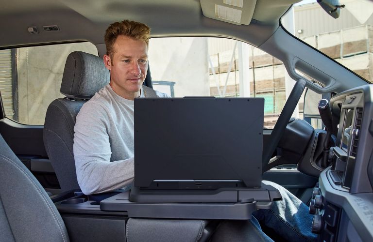 Roofing contractor using the interior work surface for his laptop