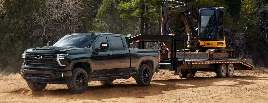 Chevrolet Silverado towing heavy machinery