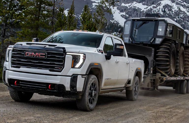 front quarter view of the GMC Sierra 3500HD towing heavy machinery