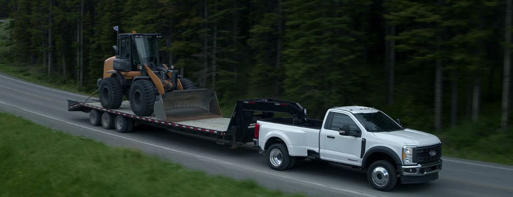 Ford Super Duty® towing heavy machinery