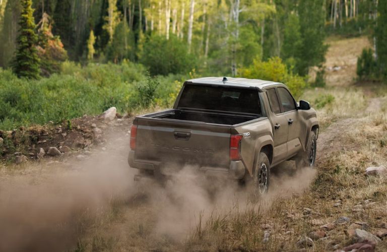 rear quarter view of the Toyota Tacoma on uneven terrain
