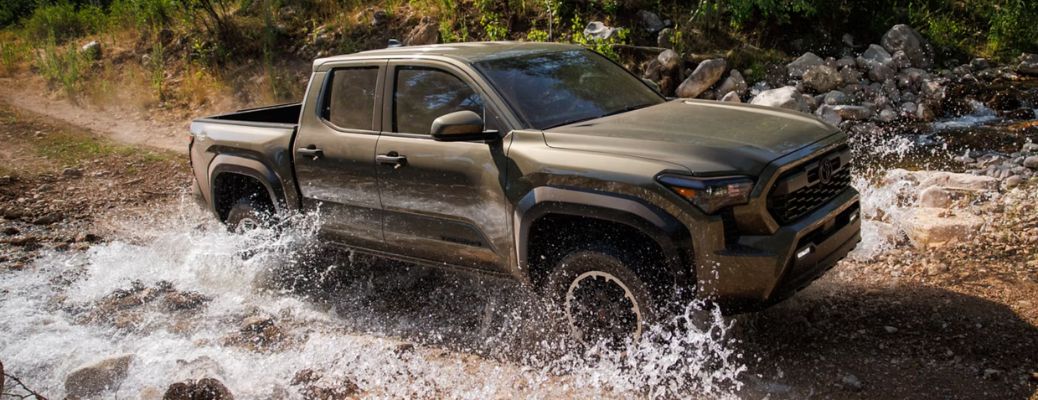 front quarter view of the Toyota Tacoma navigating a stream