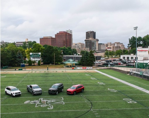 Four Kia Vehicles parked in a football field