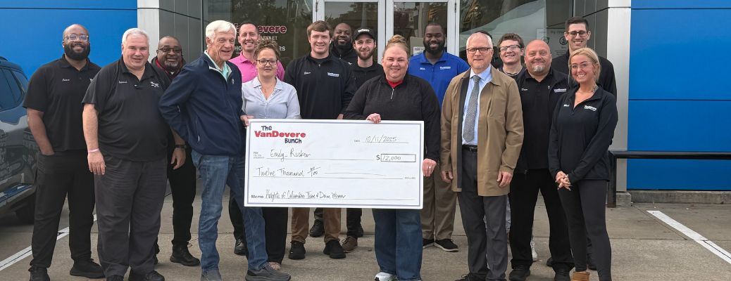 image of the VanDevere Kia team handing over prize cheque to the winner of the Thrive & Drive program