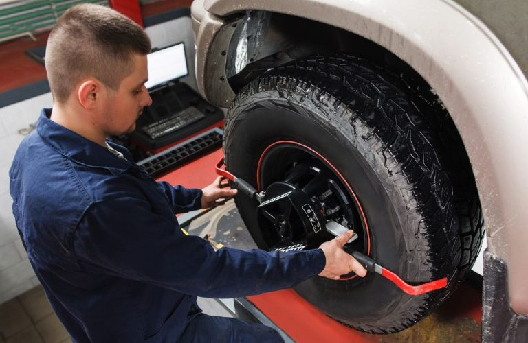 Technician fixing front-end alignment