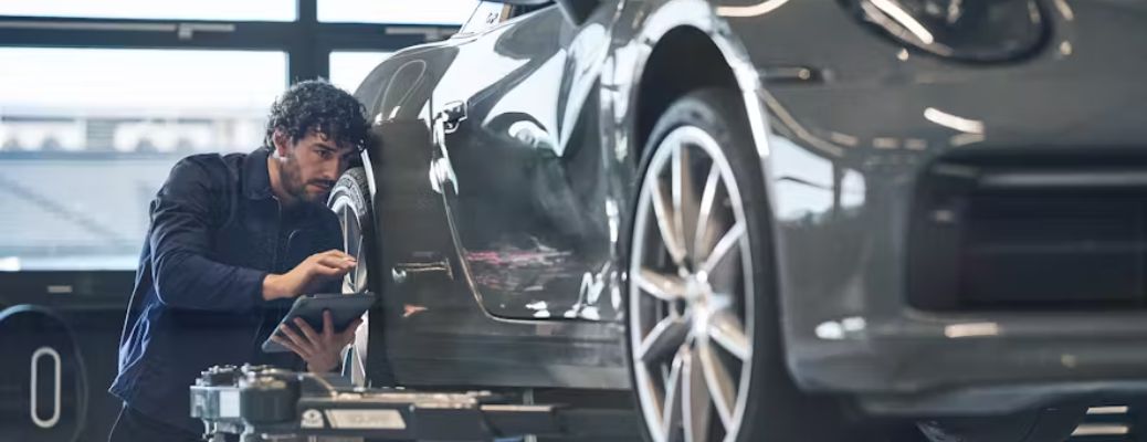A mechanic working on a vehicle at a service center