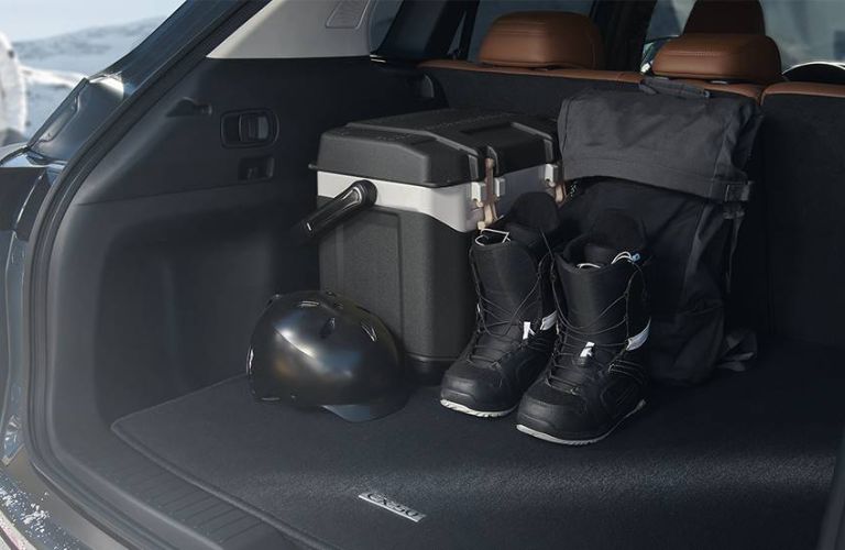 The open trunk of a 2024 Mazda CX-50 packed with cargo