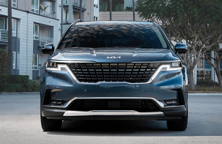 2024 Kia Carnival front view with blue paint