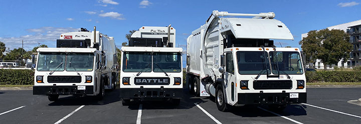 Row of Battle Motors refuse and vocational trucks lined up outside in Tampa FL Next to RDK Truck Sales
