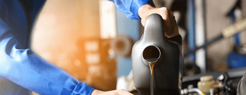 oil being poured into a car engine