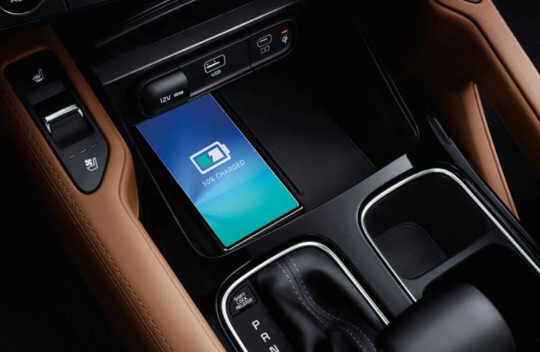 A phone being charged on the charging pad in a 2024 Kia Telluride