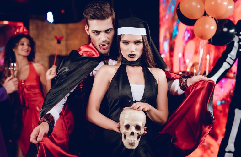 a man and woman in costume at a Halloween party