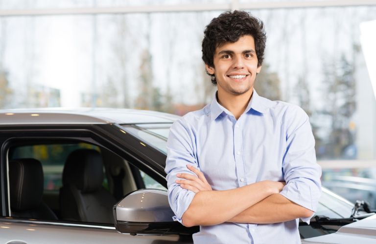 a man standing next to a car