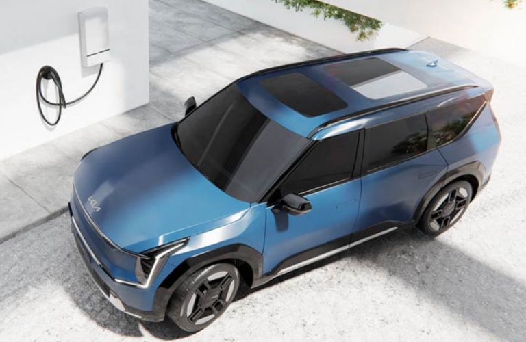 top view of a Kia next to a charger