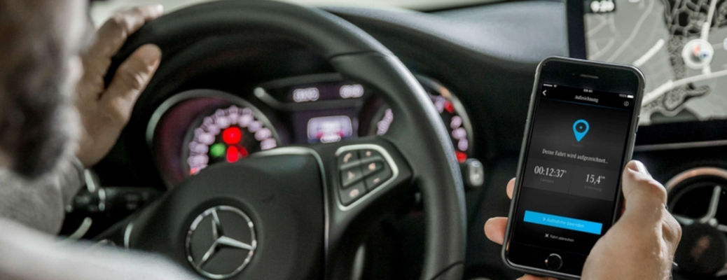 A man connecting to the on board WiFi in a Mercedes C class vehicle.