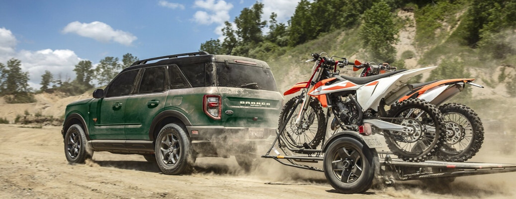 A Ford Bronco towing dirtbikes.