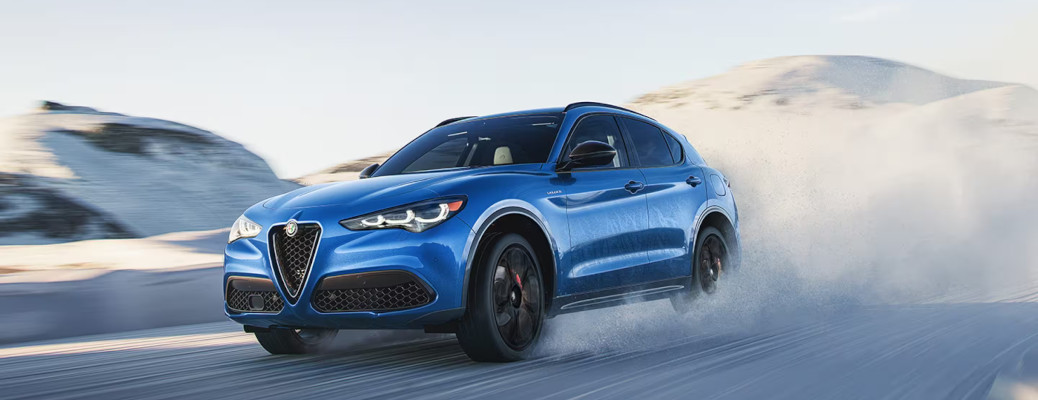 The high performance Alfa Romeo Stelvio driving in the snow.