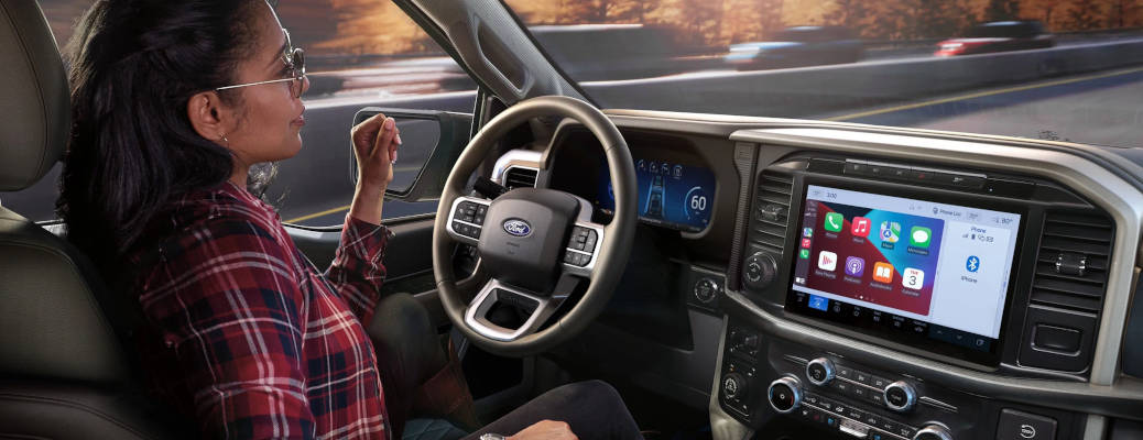 A woman enjoying the benefits of using Ford BlueCruise self-driving technology