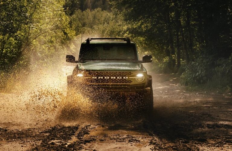 2025 Ford Bronco driving in wet mud