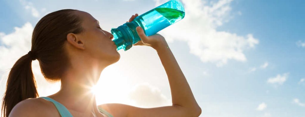 A woman drinking water to help beat the Atlanta heat