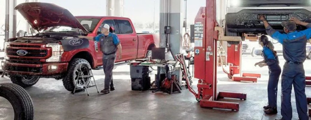 Vehicles being worked on at a Ford service center