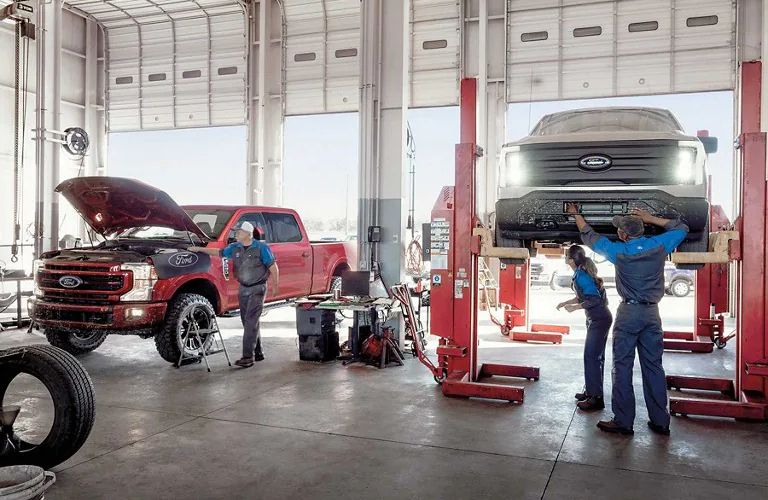 A Ford service department with technicians and cars