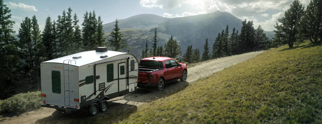The 2026 Ford Maverick towing a large camper trailer.