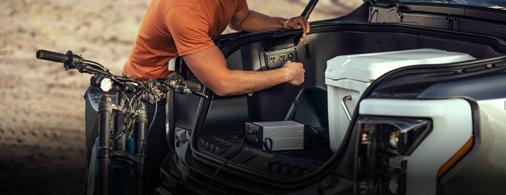 A man making use of the Ford Mega Power Frunk