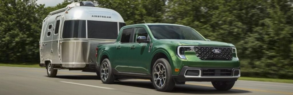 2025 Ford Maverick towing a trailer on a road