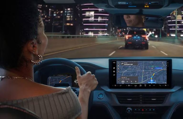 A person using the navigation system in a Ford