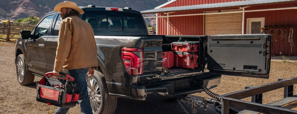A man using the configurable tailgate on the 2026 Ford F-150 PowerBoost