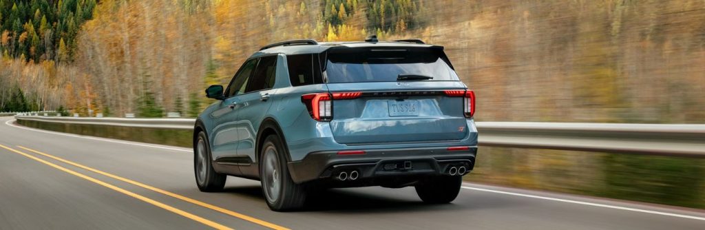 2026 Ford Explorer on a road by forests