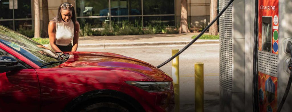 A woman charging her high performance 2026 Mustang Mach-E GT 