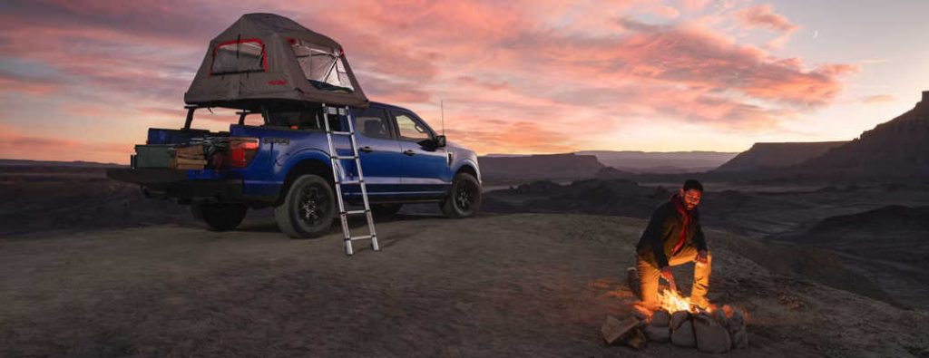 A man enjoying a safe and secure campsite with his 2026 Ford F-150