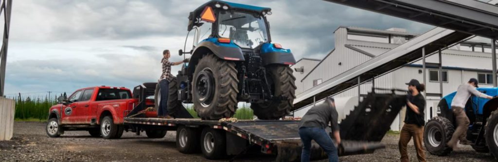 2026 Ford Super Duty truck towing a tractor