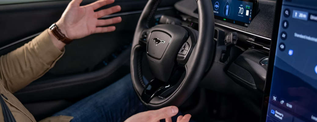 A man using the hands-free BlueCruise feature available in some Ford models.