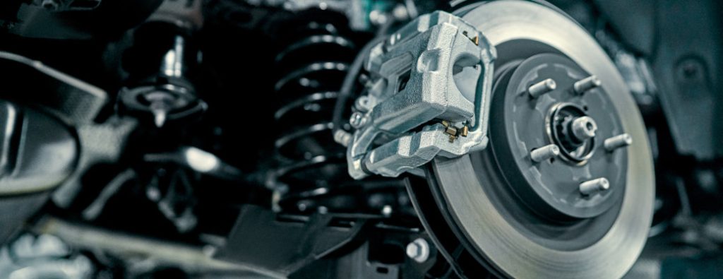The brake system of a car exposed for inspection and maintenance.
