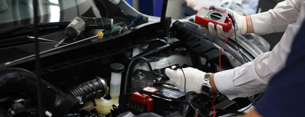 Akins Ford technical specialists checking the electrical system of a car in the shop.